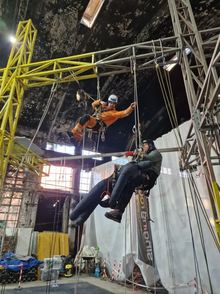 Group rope access session with several trainees suspended on ropes
