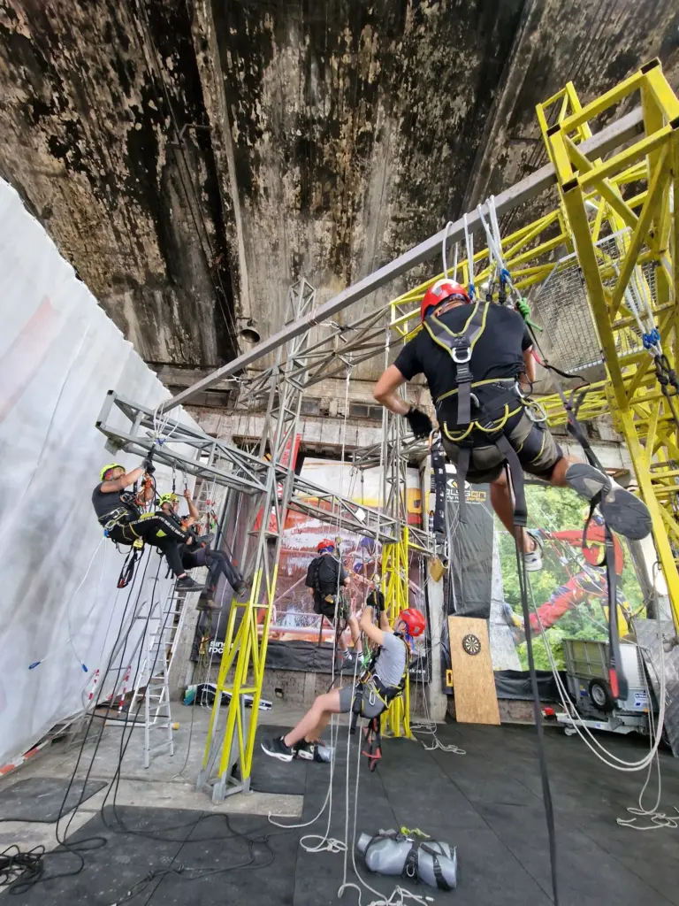 Several rope access trainees practising on suspended rope systems