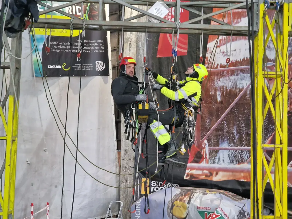 Rope access trainee practising movement on the yellow structure