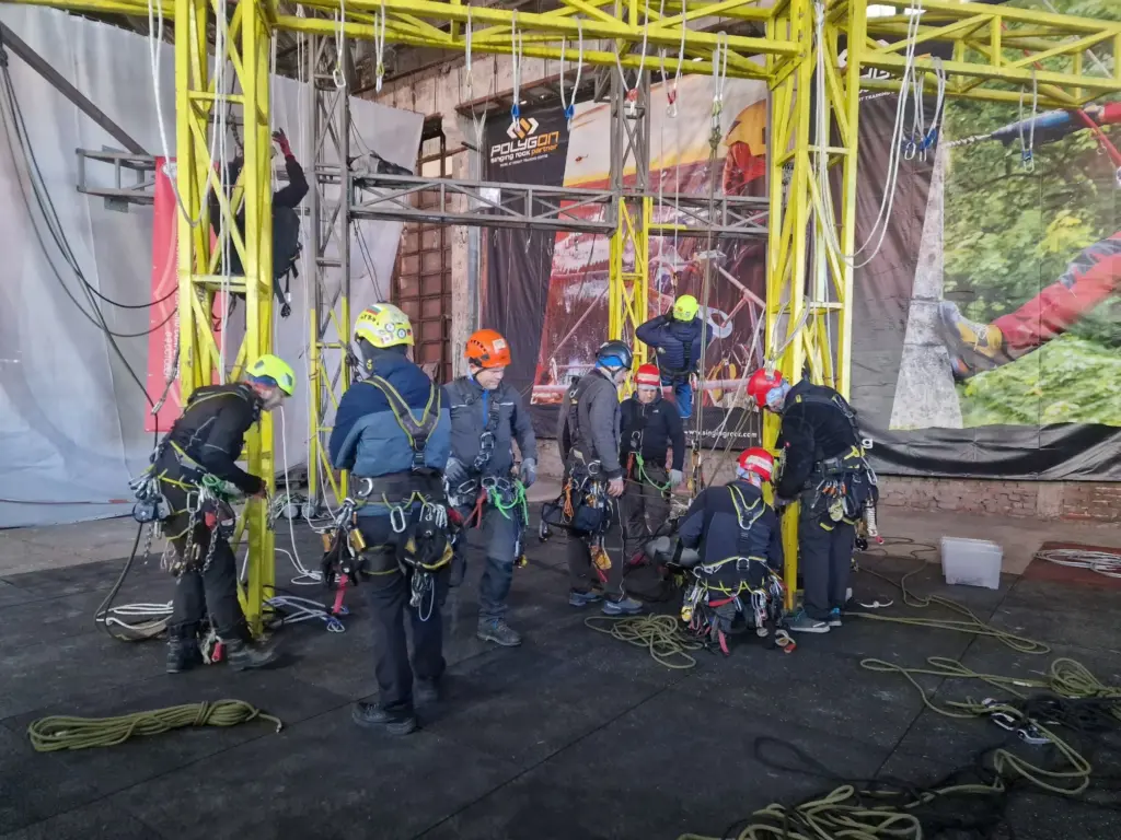 Rope access trainees preparing harnesses and equipment
