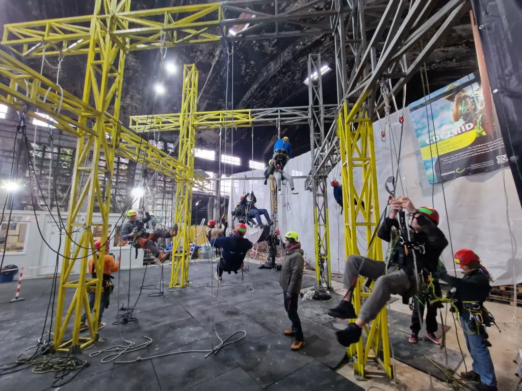Front view of the yellow rope access training structure with trainees